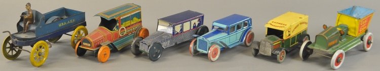 GROUPING OF TIN AUTOS AND TRUCKS: Lithographed tin examples include Chein sedan in blue body, Rapid Delivery truck, Non-Pareil Limousine sedan, Sand and Gravel dump truck, U.S.A. A.E.F. dump truck, and Wells Express Transport truck.