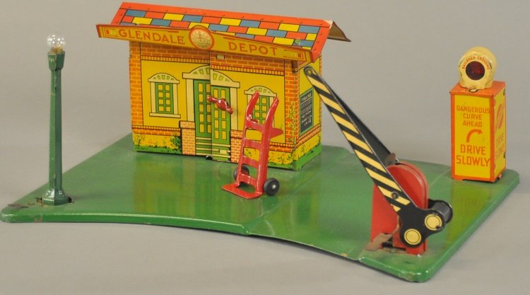 MARX GLENDALE RAILROAD STATION: Lithographed tin, portrays "GLENDALE DEPOT" with crossing gate, warning signal, lamp post and hand cart, very colorful graphics, well detailed overall. 10" x 13 1/2".