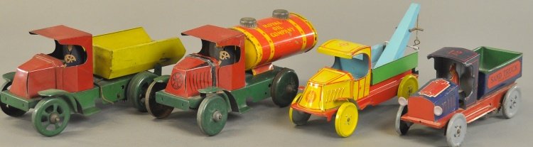 LOT OF FOUR TIN WORK VEHICLES: All done in lithographed tin, includes: Strauss Sand truck, Chein Wrecker, Marx Royal Oil truck and Dump truck, two have key wind mechanism. 8" - 10" l.