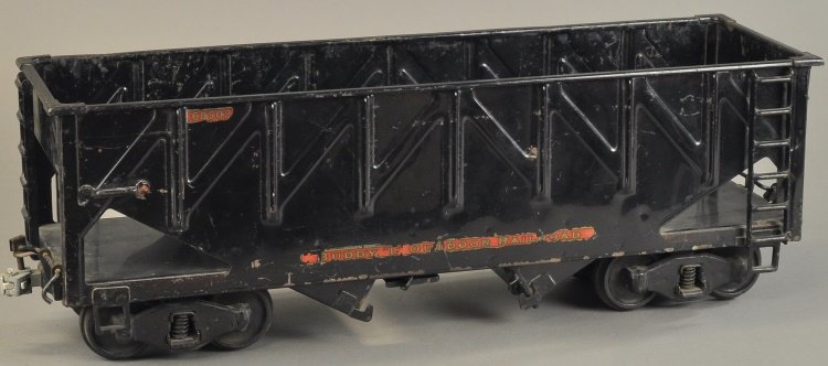 BUDDY 'L' OUTDOOR RAILROAD BOTTOM DUMP (HOPPER) #1: circa 1928, pressed steel body painted in black overall, well embossed detailing to sides, floor features two hinged doors with latch, allowing hoppers to open for unloading, decal reads, "68502." 21"