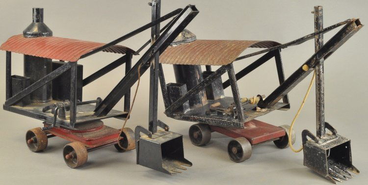 BUDDY 'L' STEAM SHOVELS: Early 1921-1923, pressed steel, vertical boiler on frame housing, red corrugated roof, easy pull on roller wheels, black scoop shovels, and swivel bases. 21" l.