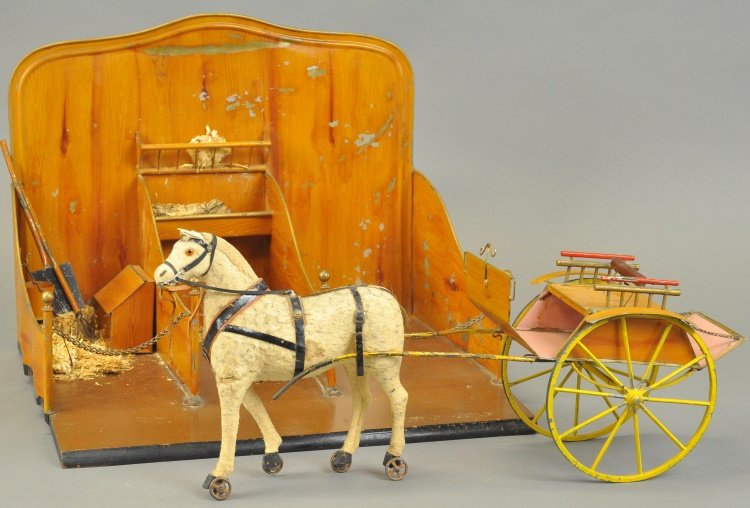 THREE STALL TIN STABLE: France, hand painted overall, done in finely simulated wood grain finish, nice form, three stall stable includes: original spoke wheels trap with horse, feed box and barn tools. Ex. Ingersoll Collecti