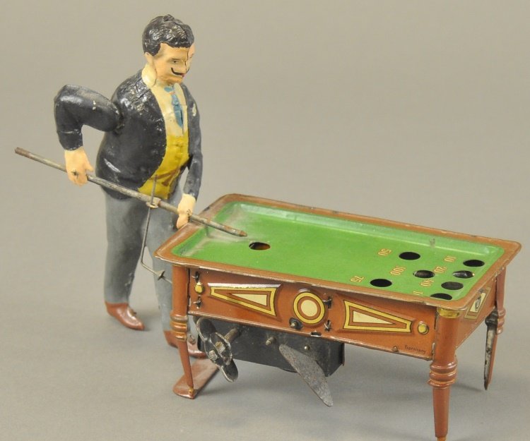 BILLIARDS PLAYER: Germany, tin attributed to Gunthermann, billiards player is clockwork activated, nice detail to gold stenciled table, simulated felt top table. 8" l.