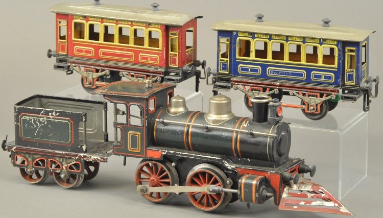 KARL BUB GAUGE I TRAIN SET: Germany, includes an 'I' gauge, clockwork driven 0-4-0 steam type engine in green with red and yellow trim and matching tender, together with two lithographed tin coaches, one in red, one in blue. Car