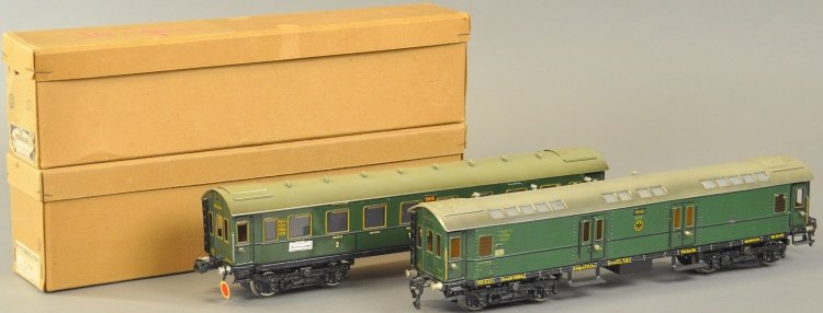 MARKLIN PASSENGER AND MAIL CAR: Germany, #19410 AND #19450, 'O' gauge, both done in green body, eight wheels, passenger car has destination labels on sides, both boxed examples. 15 3/4" l.
