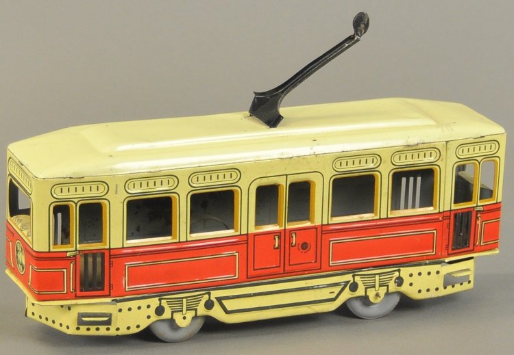 GUNTHERMANN TROLLEY: Germany, lithographed tin, red and yellow body, electric pole on roof, keywind driven, engineer's compartment has dashboard graphics. 12" l.