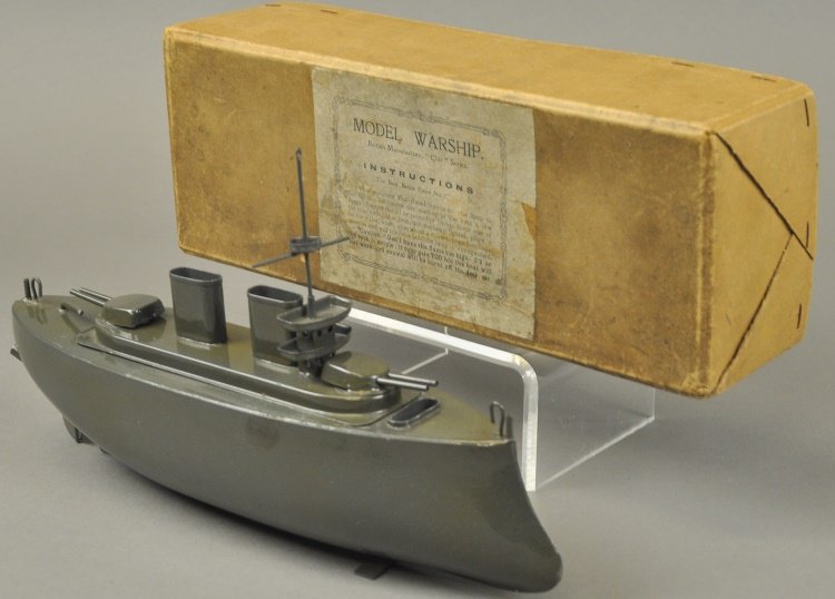 BOXED SUTCLIFFE BATTLESHIP: England, circa 1930's, heavy tinplate vessel painted in dark grey overall, putt putt engine, deck appointments include: mast, observation deck and gun turrets. Ex. Dick Claus Collection. 12" l.