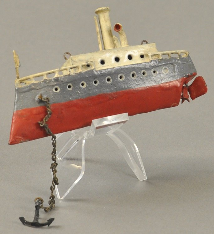STEAM BOAT: Germany, hand painted lead example, hull done in red and grey, white upper deck features cabin with solo stake, two ventilators and anchor, rail on bow and stern. 3 1/4" l.
