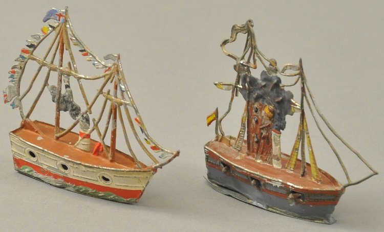 LOT OF TWO EARLY WARSHIPS: Germany, hand painted lead examples, features an exploding ship with guns at hull sides and steamship with full pennant banner at rigging, similar hull styles. 3 1/2" l.