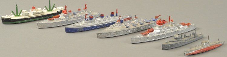 GROUPING OF TOOTSIETOY SHIPS: Die-cast examples, most in grey painted bodies, includes: five military styled ships, one freighter with deck cranes and one ocean liner. 4" - 6" l .