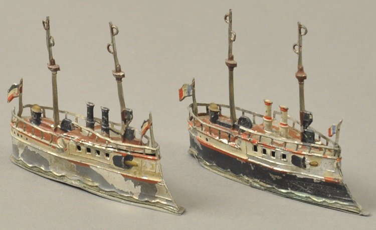 LOT OF TWO WARSHIPS: Germany, hand painted lead example, similar styling, varied paint scheme, each features two masts, embossed guns, two stacks, flags and fully railed. 3 1/2" each.
