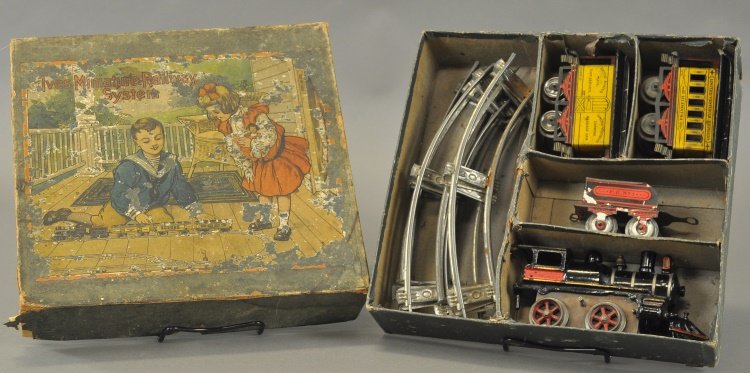IVES BOXED 'O' GAUGE HIAWATHA TRAIN SET: c. 1906, includes 0-4-0 clockwork #17 engine in cast iron with tin "F.E. No. 1" tender, together with #51 yellow Hiawatha and #50 baggage car, both with hand painted roofs and loop couplers, track inc