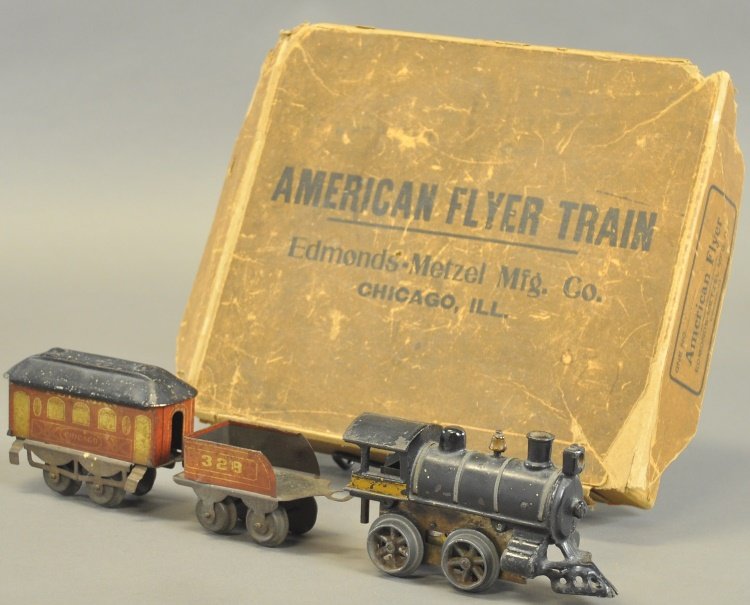 AMERICAN FLYER EDMONDS METZEL CHICAGO TRAIN SET: circa 1905-1906, set includes cast iron 0-4-0 clockwork locomotive with gold window trim and #328 red lithographed tender, together with four wheel lithographed red closed window "Chicago" pullman, lo
