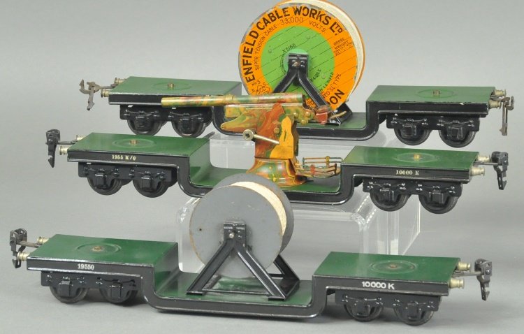 THREE MARKLIN DEEP WELL FLAT CARS: Germany, each has recessed centers that hold wire reels and one with anti-aircraft gun, flat cars are all eight wheel examples. 12 1/4" l.