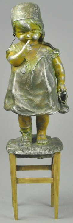 GIRL HOLDING SHOE DOORSTOP: White metal, depicts young girl fully attired in night clothes standing on chair and holding shoe in one hand and finger to lips to demand silence in other, rare form. 11 1/2" h.