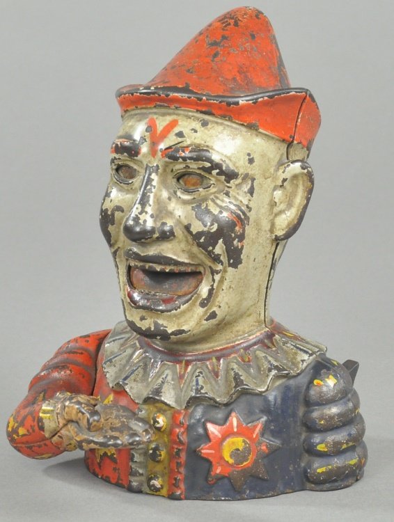 HUMPTY DUMPTY MECHANICAL BANK: Patent No. D-255,000 on 3/14/1882. Shepard Hardware Co., designed by Charles G. Shepard & Peter Adams, patented 3/14/1882. The coin is placed in the hand, the arm is then raised by a small projecting