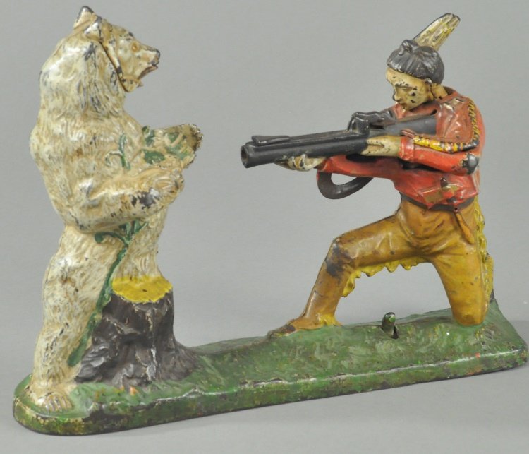 INDIAN SHOOTING WHITE BEAR MECHANICAL BANK: J. & E. Stevens Co., designed by Charles A. Bailey, CT, circa 1907, cast iron, white version, coin is placed on rifle and pressing lever allows coin to shoot into bear's chest slot, paper caps can be 