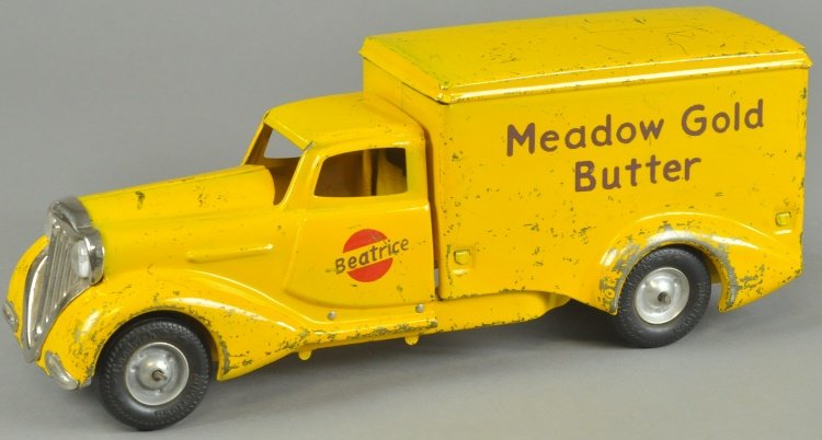 METALCRAFT "MEADOW GOLD BUTTER" TRUCK: c. 1930's, pressed steel, streamlined electric light version, van body lettered in brown, door reads, "Beatrice," painted in yellow overall, black lettering. 13" l.