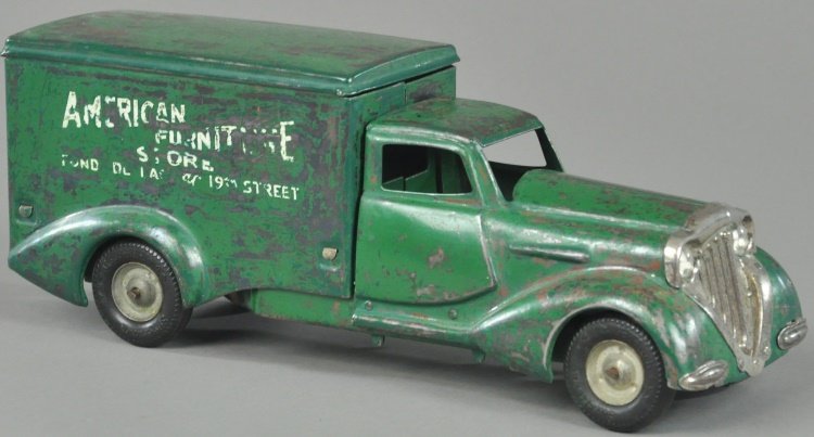 METALCRAFT "AMERICAN FURNITURE" DELIVERY TRUCK: Pressed steel, painted in green overall, deco styled cab, enclosed van body has white store lettering on sides, electric lights, rubber tires. 13" l.