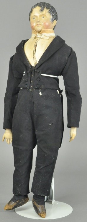 ALL ORIGINAL PRE-GREINER" BOY DOLL: Unmarked papier mache shoulder head with molded and painted features, soft "wind blown" hair and comb marks, on cloth body with separately sewn fingers, wearing black wool tuxedo and heavily starched 