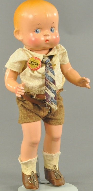 SKIPPY DOLL: Composition "Skippy" doll by Effanbee with molded and painted facial features with original brass identifying button, "I am SKIPPY - The real American Boy." 13 1/2" (34cm)