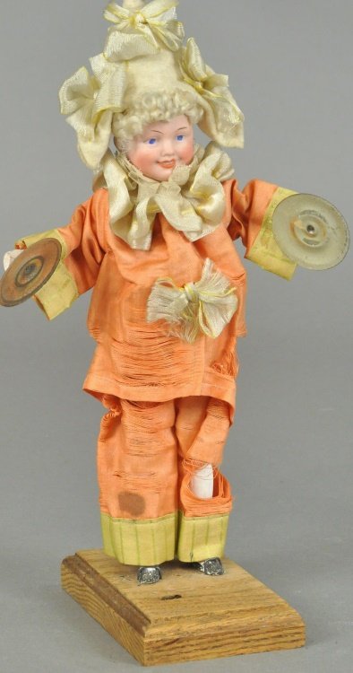 ALL ORIGINAL CYMBAL PLAYER DOLL: Semi-mechanical toy with smiling bisque socket head with painted features, and open/closed mouth with molded teeth, when mechanism in belly is pushed, arms move forward to clash the cymbals. 9 1/2" (2