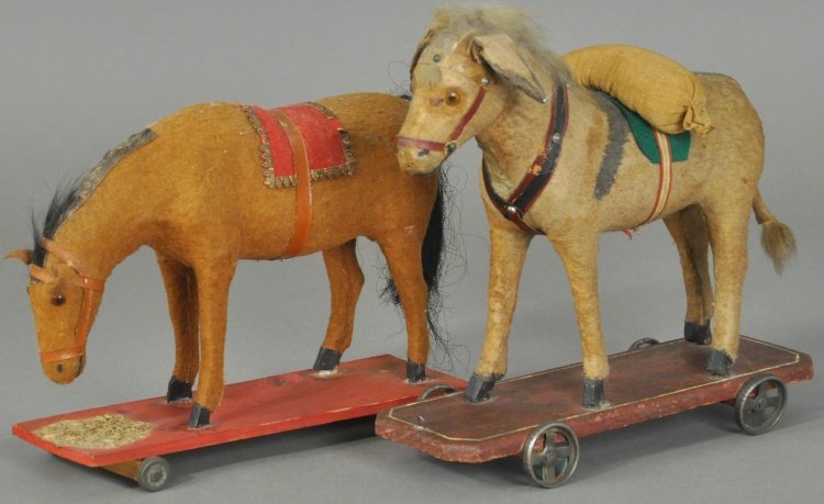 HORSE AND DONKEY ON PLATFORMS: Both in standing pose, one appears to be eating hay from base, Donkey carries bag on back, applied glass eyes, both German made with felt covering. 9" l.