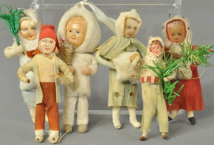 GROUPING OF COTTON ORNAMENTS: Includes: celluloid face child with tree, paper face child with tree, peasant boy wearing paper clothes, child with tree and candy cane in hand, girl with feather tree and girl with muff. 3 1/2" - 4 1