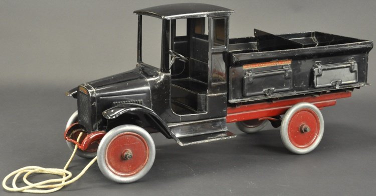 BUDDY 'L' SAND AND GRAVEL TRUCK: Enclosed doorless cab, interesting and detailed open body features inverted "V" bottom for unloading, sides have opening, hinged doors, a true likeness and scale version of the real 1920's work vehicl