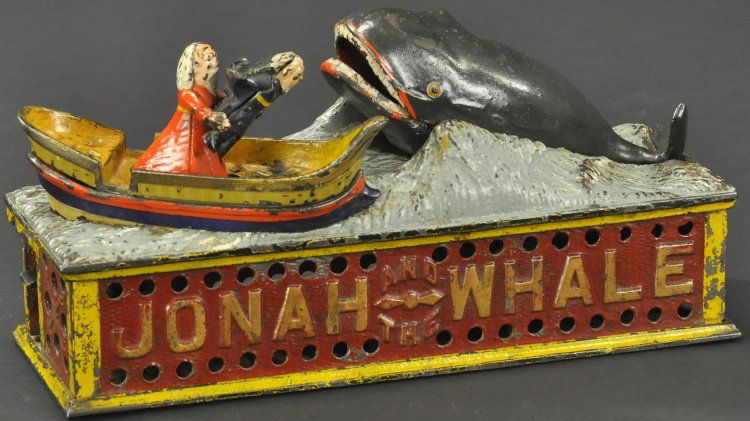 JONAH AND THE WHALE MECHANICAL BANK: Shepard Hardware Co., designed by Peter Adams, circa 1890, cast iron, place coin in Jonah's tray and pressing lever allows man to seemingly throw Jonah as coin is deposited into whale's mouth.
