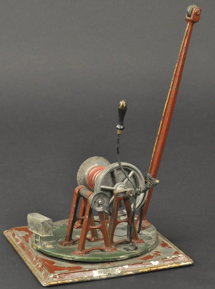 SCHOENNER CRANE: Rare example, hand painted revolving brown base, green platform, brown boom with hook, reel is steam powered. 9 3/4" h.
