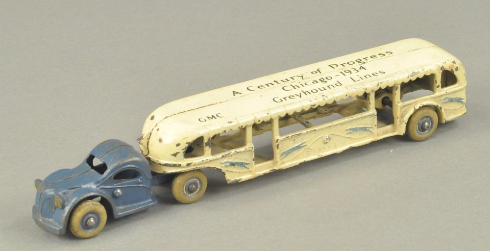 ARCADE CENTURY OF PROGRESS CHICAGO 1934 GREYHOUND: c. mid 1930's, cast iron tandem bus, roof stenciled, "Century of Progress Chicago -1934," rubber tires. 10" l.