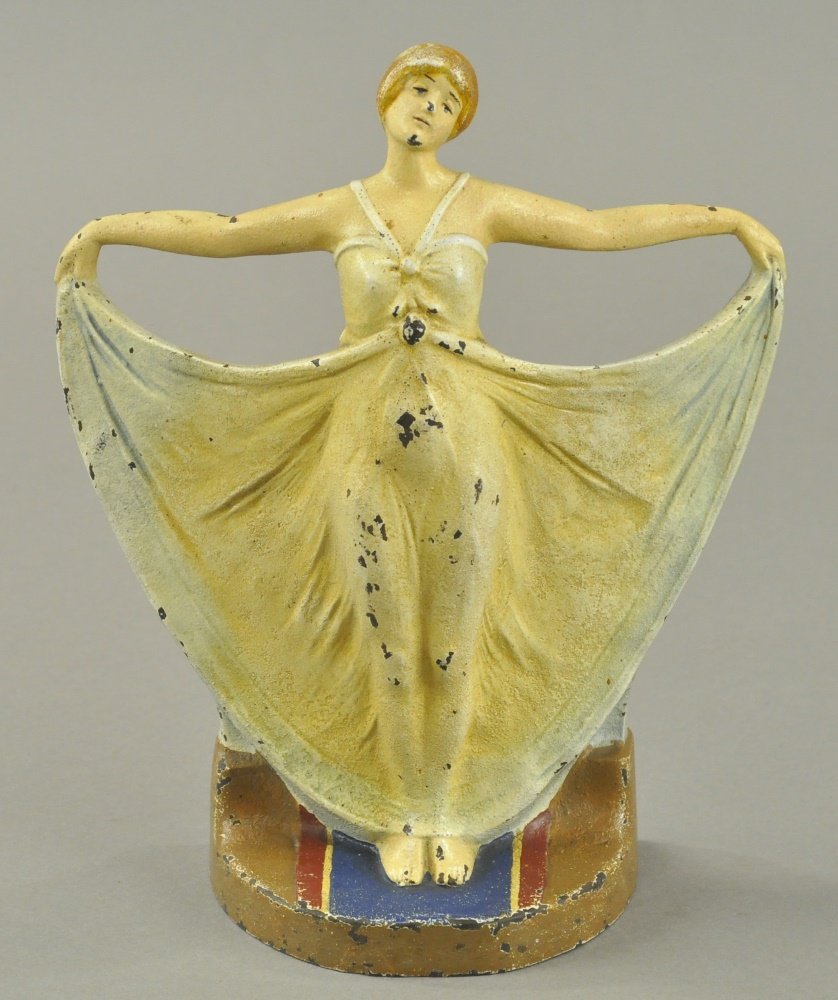 DECO GIRL DOORSTOP: CJO 1251, classical and superb casting of deco period girl with outstretched arms holding elegant dress. 9 1/4" h.