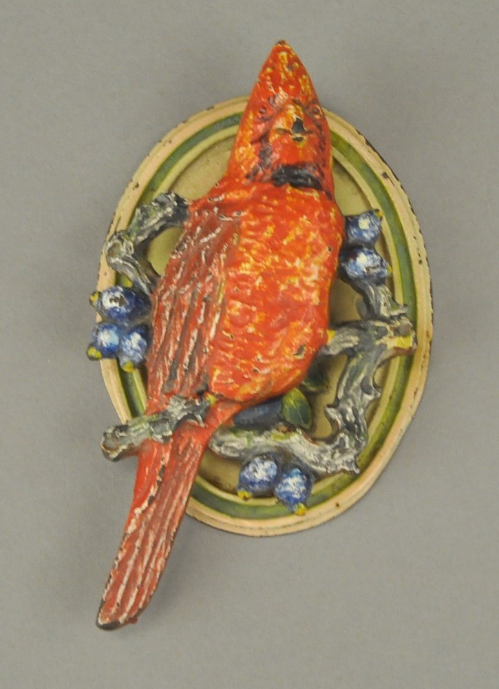 CARDINAL DOORKNOCKER: Beautiful bird sitting in branches of tree, bright red coloring. 4 1/2" h.