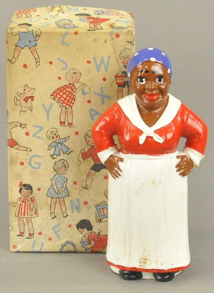 HUBLEY MAMMY STILL BANK: Hubley, Lancaster PA, cast iron, includes original box, painted in familiar red and white outfit, appears to be old store stock, familiar children depicted on Hubley box. Provenance: Bob Brady Collect