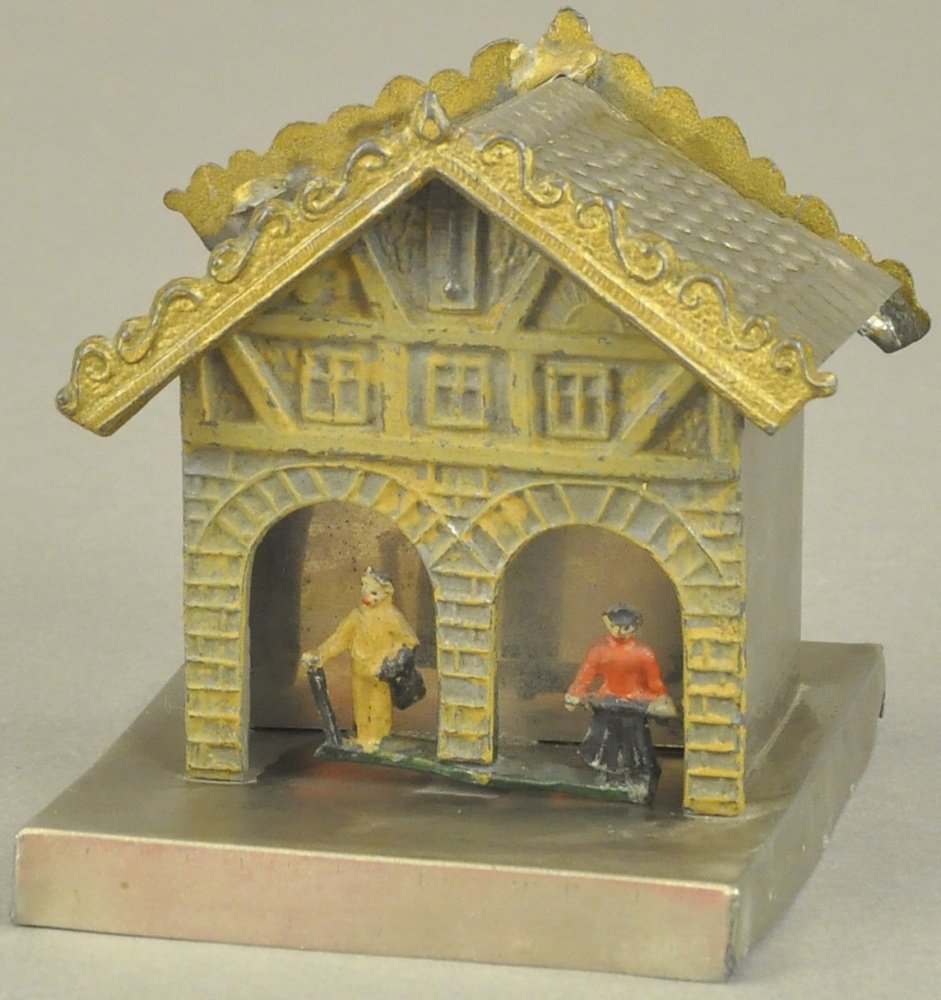 BUILDING MECHANICAL BANK w/LEAD FIGURES IN DOORWAY (1 of 2)
