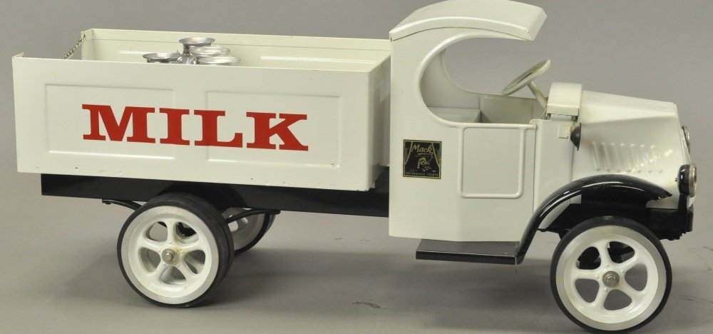LES PAUL MACK MILK TRUCK: Contemporary example, pressed steel truck is painted in white body, reads MILK on sides, rubber tires with spoke wheels. 23 1/2" l.