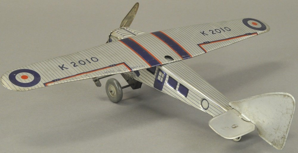 METTOY PASSENGER PLANE: England, lithographed tin, silver, blue and red fuselage, single prop, wind-up action, striped graphics overall. 16 1/2" wing.