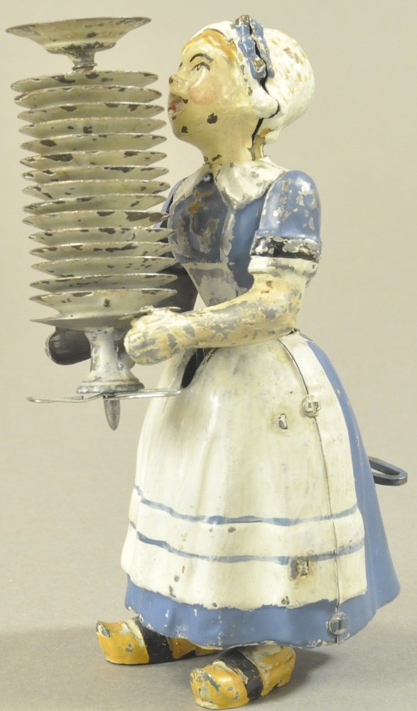MADELON THE MAID CARRYING DISHES: Fernand Martin, France, hand painted figure of Dutch girl with stack of plates in hand, clockwork plates, quite amusing. 6 1/2" h.