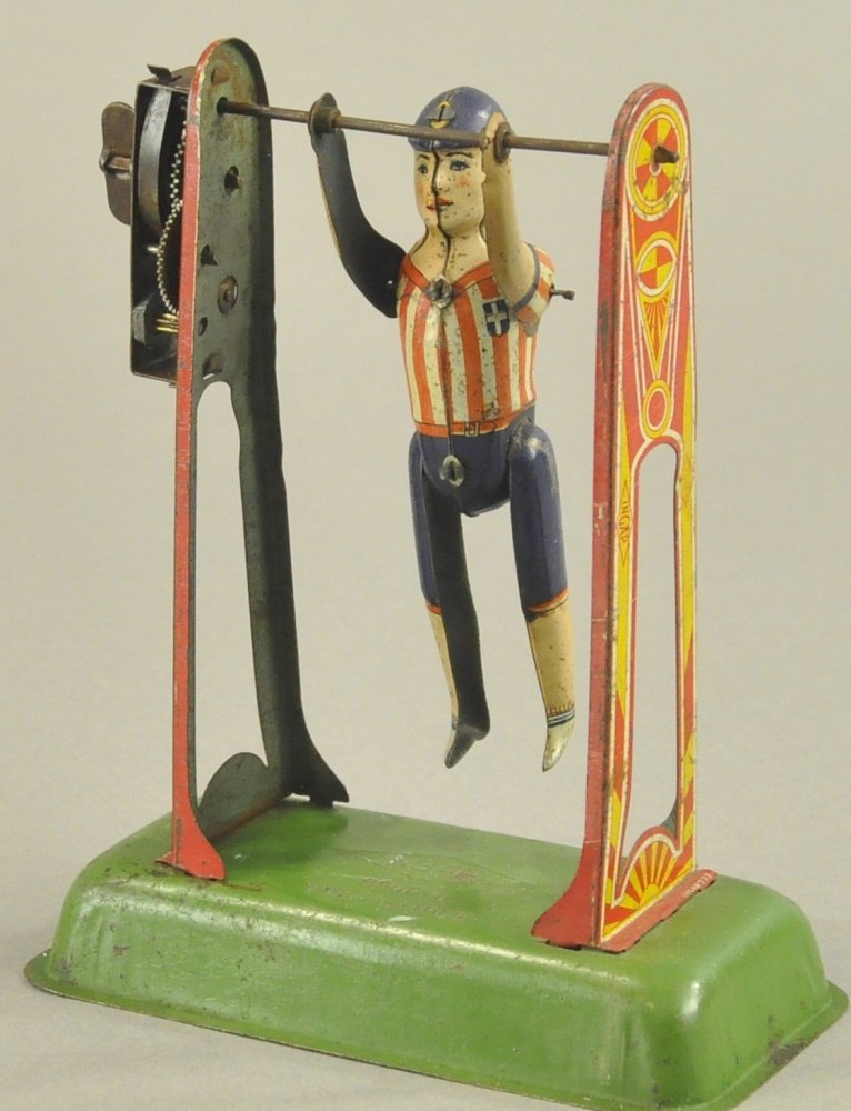 INGAP GYMNIST TOY: Wind up toy allows boy in uniform to perform on lithographed frame gymnastic bars, very colorful. 5" l.