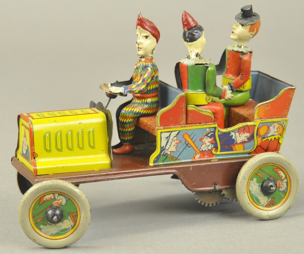 HANS EBERL "TA-RA-RA-BUMM" CLOWN CAR: Germany, c. 1920's, hand painted and lithographed tin, great graphic images surround tin open car with three seated clowns, each with hand painted head, one holds umbrella, one steers and one holds ca
