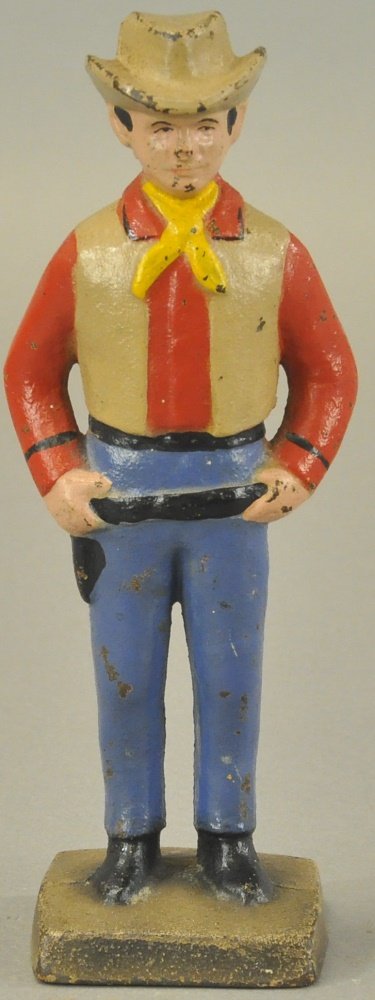 COWBOY DOORSTOP: Full figure, proud and cheery colored cowboy stands with hands on gun belt. 8 1/2" h.