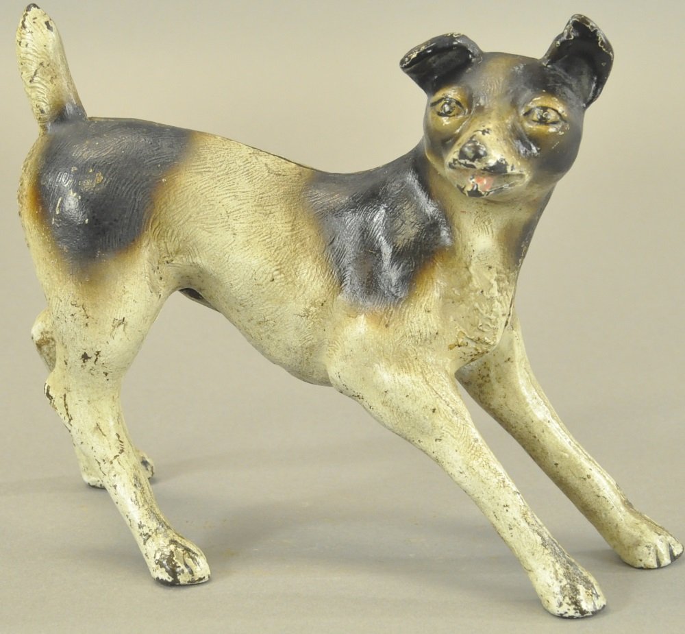 TERRIER IN SPREAD STANCE DOORSTOP: Full figure terrier in playful spread stance and ready to pounce, whimsical and rare example. 7 7/8" h.