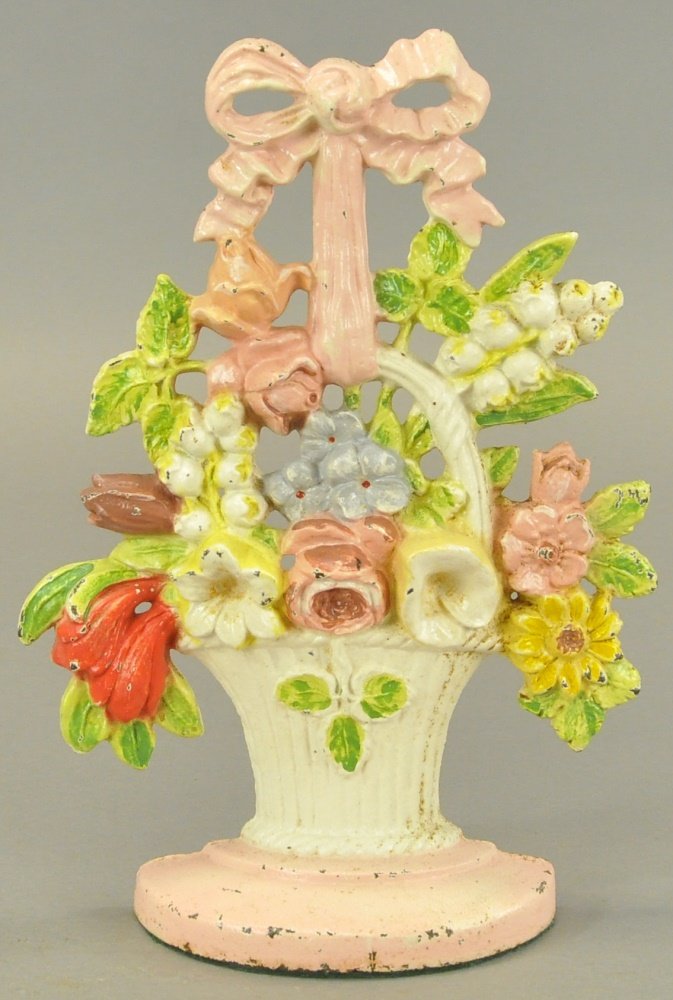 LILLIES OF THE VALLEY DOORSTOP: Hubley "89," features charming floral setting in white basket with pink highlights. 11" h.