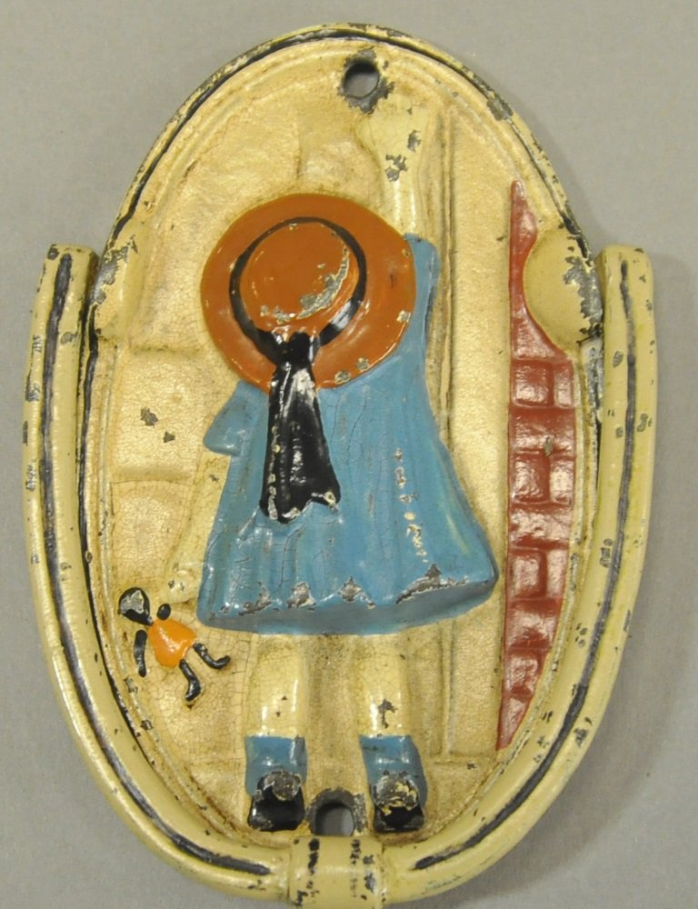 GIRL KNOCKING AT DOOR DOOR KNOCKER: Cast iron, girl dressed in blue and brown hat holding doll knocking at door, adorable theme, very rare. 4" h.