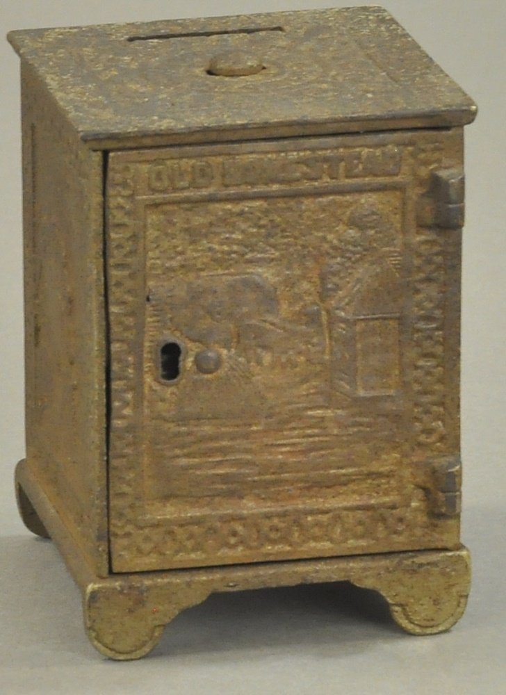 OLD HOMESTEAD KEY SAFE STILL BANK: Shimer, key lock door variation, very rare, c. 1899, cast iron, very ornate molding, lettered "Old Homestead." 4 1/4th" h.