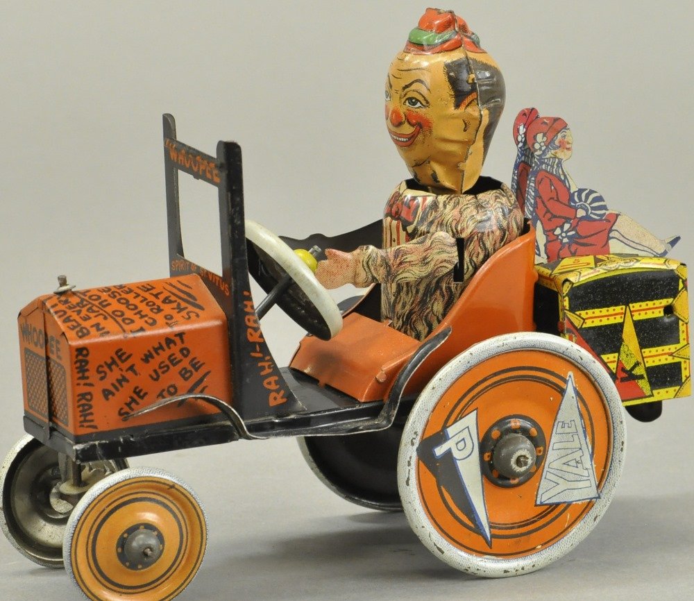 YALE PRINCETON WHOOPEE CAR: Louis Marx, lithographed tin, comical toy depicting college bound student with girl die-cuts on suitcase, clockwork driven. 8" w.