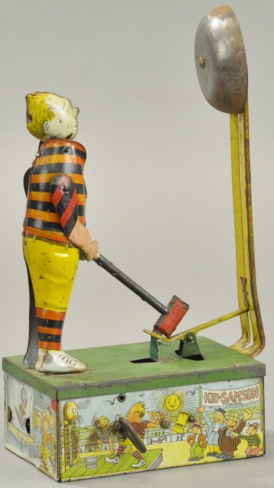 B&R KID SAMSON: Behrend & Rothschild, NY, lithographed tin, depicts standing figure ready to strike carnival bell, base shows graphic images of children and carnival. 9 1/2" h.