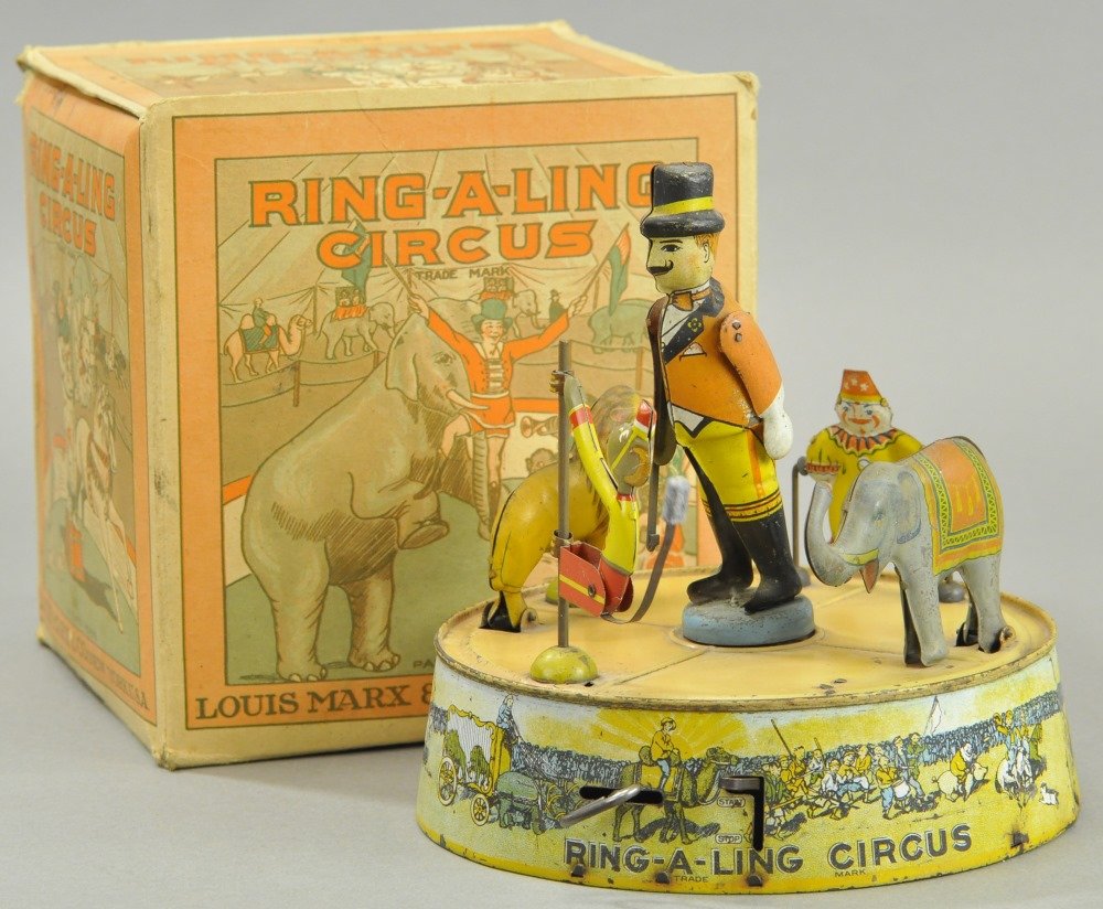 RING-A-LING CIRCUS WITH BOX: Louis Marx, lithographed tin, features ringmaster directing elephant, lion, clown and performing monkey on base, includes box. 7" l.