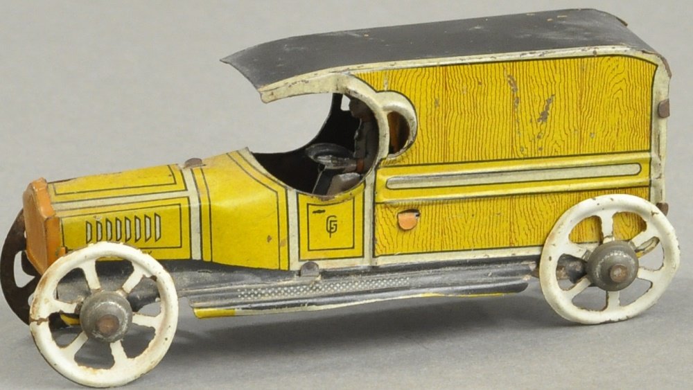 DELIVERY VAN PENNY TOY: Fischer, Germany, features yellow delivery van with wood grain litho and white spoke wheels. 4 1/4" l.
